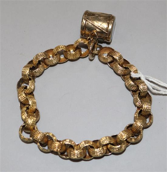 A late Victorian gold fancy link bracelet with drum charm.